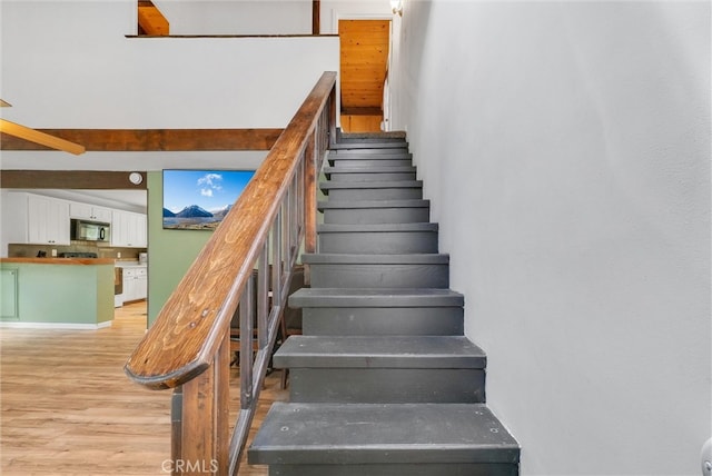 stairs featuring hardwood / wood-style flooring