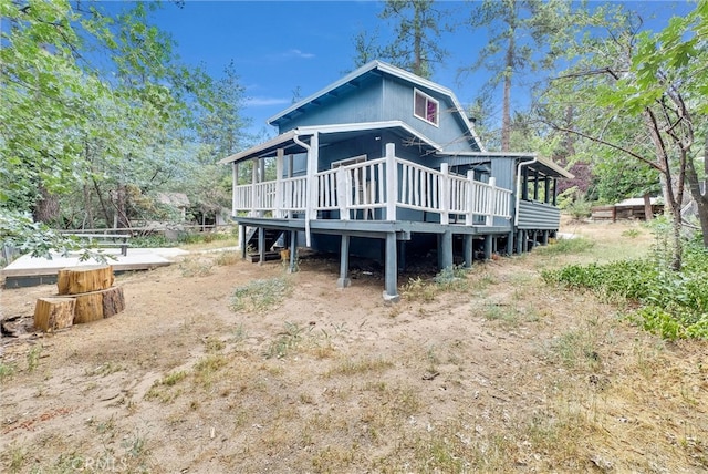 back of house with a wooden deck