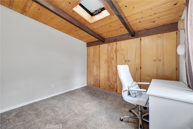 unfurnished office featuring a skylight, wooden ceiling, carpet flooring, and beam ceiling