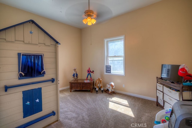 recreation room featuring light carpet and ceiling fan