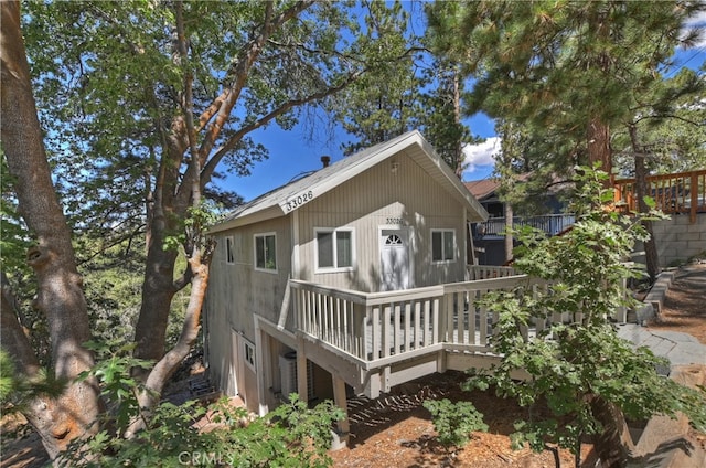 back of property with a wooden deck