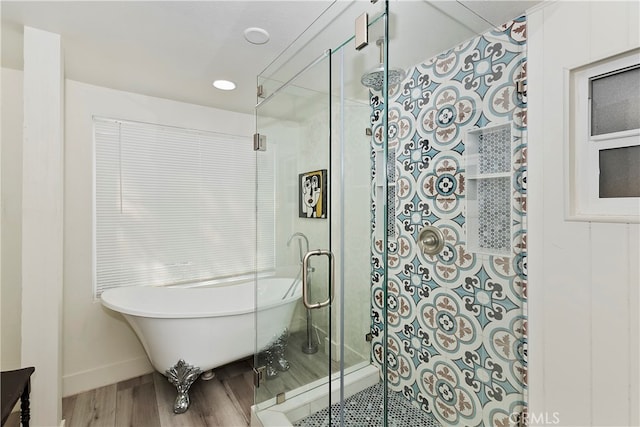 bathroom featuring a shower with shower door and wood-type flooring