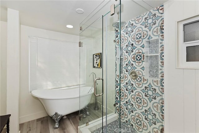 bathroom with separate shower and tub and wood-type flooring