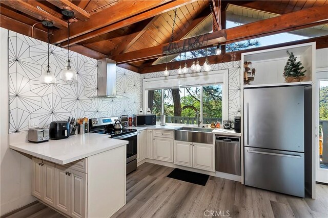 kitchen featuring light hardwood / wood-style floors, decorative light fixtures, wooden ceiling, wall chimney exhaust hood, and appliances with stainless steel finishes