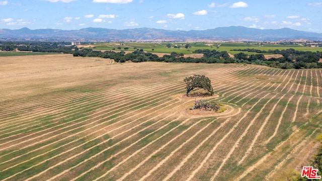 drone / aerial view featuring a rural view and a mountain view