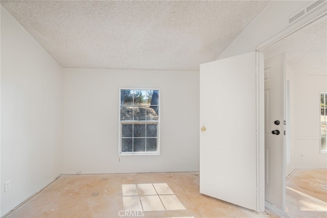 unfurnished room with a textured ceiling