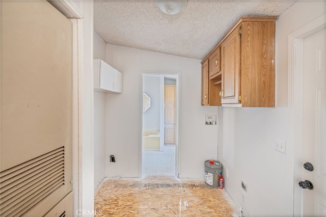 clothes washing area with a textured ceiling and electric dryer hookup