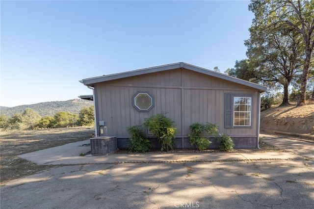 view of outdoor structure featuring a mountain view and central AC unit