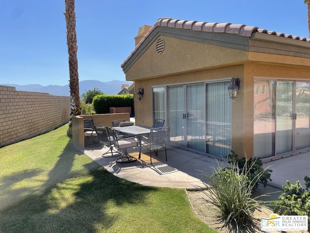 exterior space with a mountain view and a patio