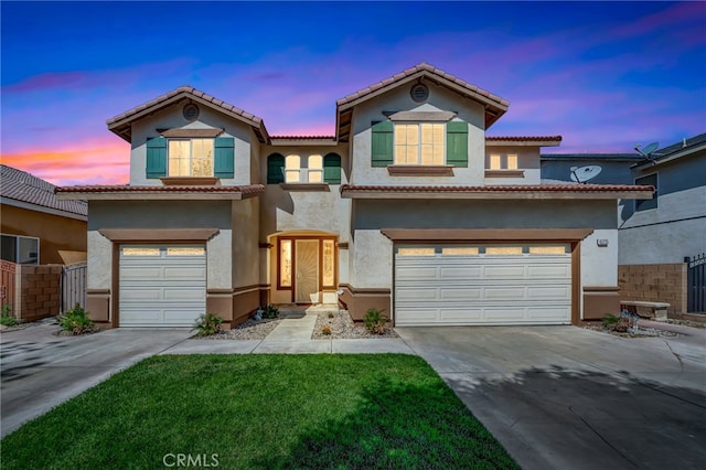 view of front of home with a lawn and a garage