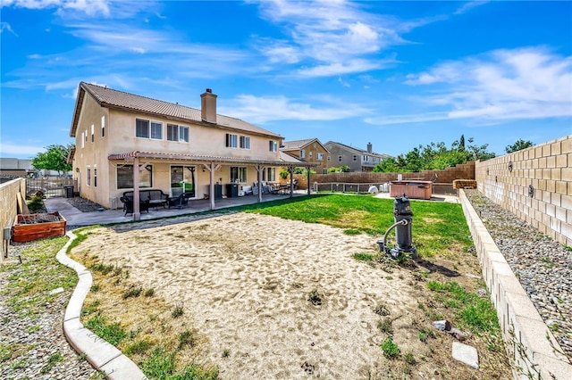 rear view of property featuring a yard and a patio area