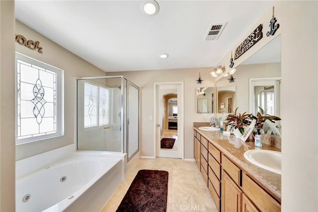 bathroom with double sink vanity, tile flooring, and independent shower and bath