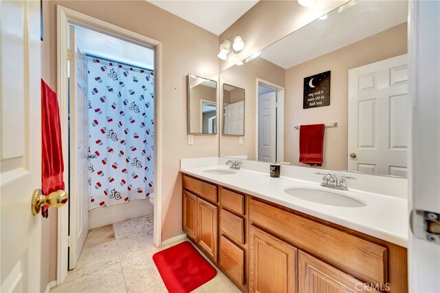 bathroom with tile flooring, double sink, and oversized vanity