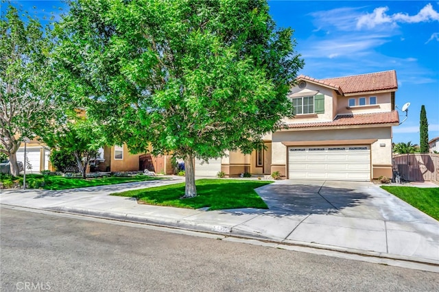 view of property hidden behind natural elements with a front lawn and a garage