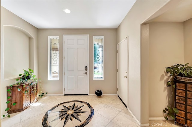 tiled entryway with a wealth of natural light