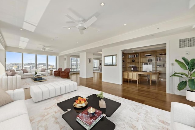 living room featuring ceiling fan and hardwood / wood-style flooring