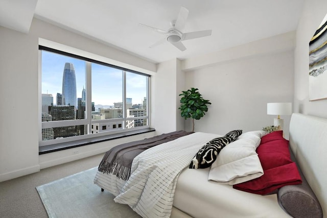 bedroom with light carpet and ceiling fan