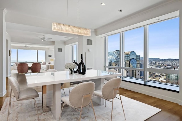 dining room with ceiling fan and light hardwood / wood-style flooring