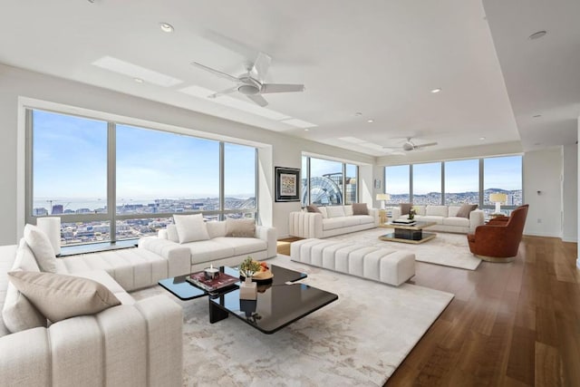 living room with ceiling fan and light hardwood / wood-style flooring