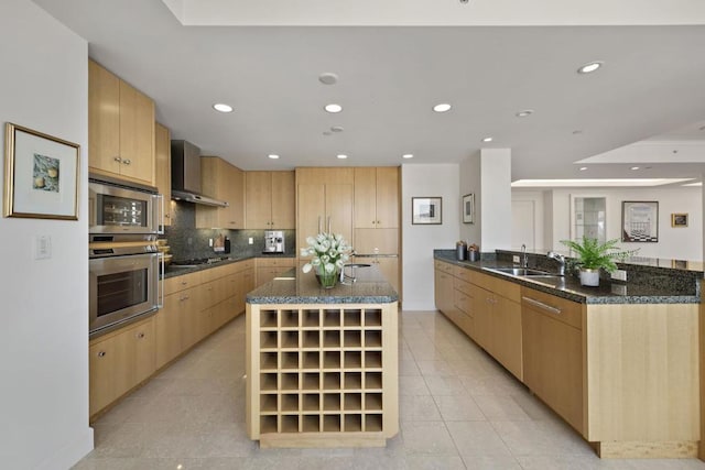 kitchen featuring sink, stainless steel appliances, light tile flooring, wall chimney range hood, and a center island