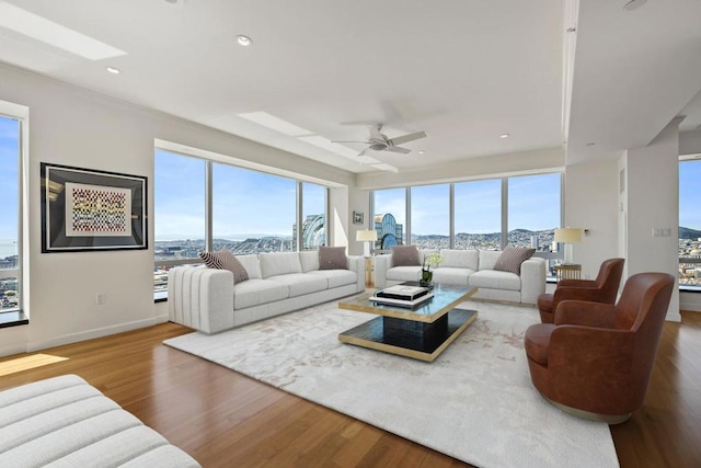 living room with ceiling fan, a wealth of natural light, and hardwood / wood-style floors