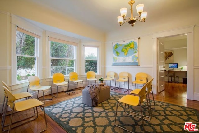 dining space with an inviting chandelier and hardwood / wood-style floors