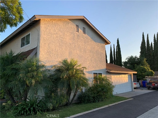 view of side of property with a garage