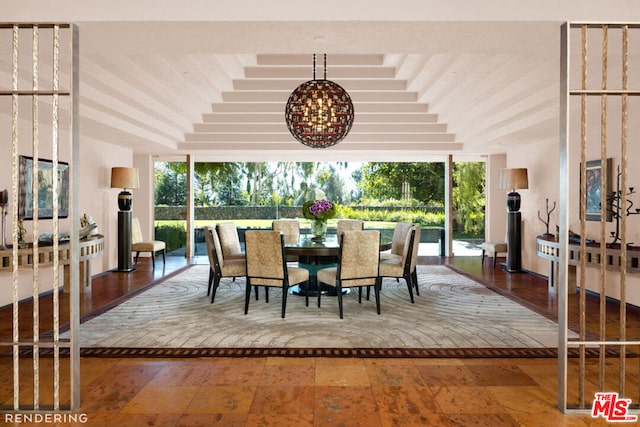 dining room with a wall of windows, a raised ceiling, and a notable chandelier