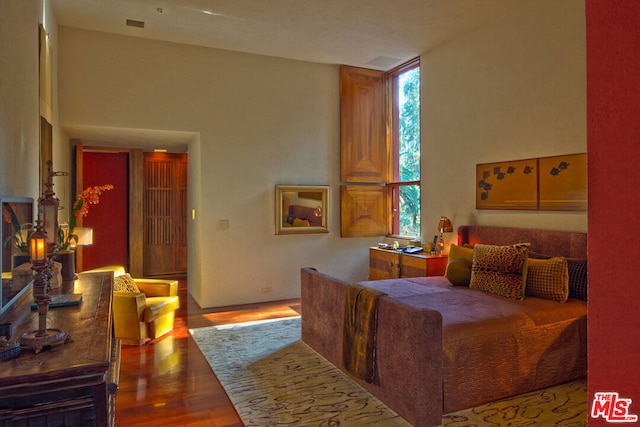 bedroom featuring multiple windows and hardwood / wood-style floors