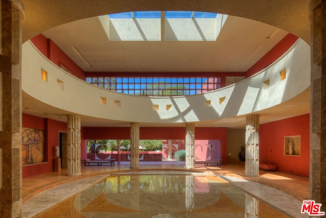 view of swimming pool with a skylight