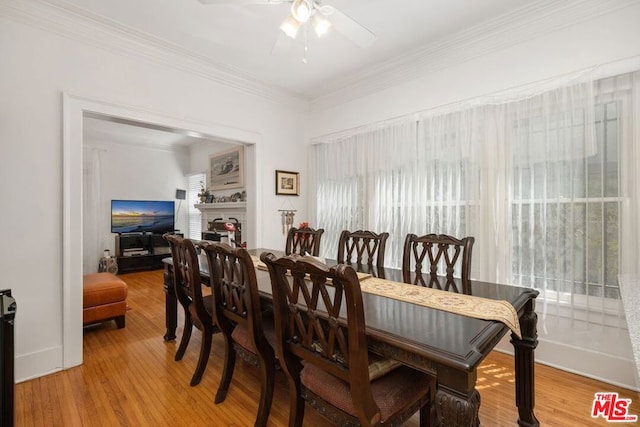 dining area with crown molding, light hardwood / wood-style floors, and ceiling fan