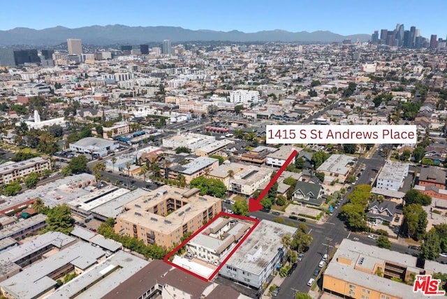 birds eye view of property featuring a mountain view