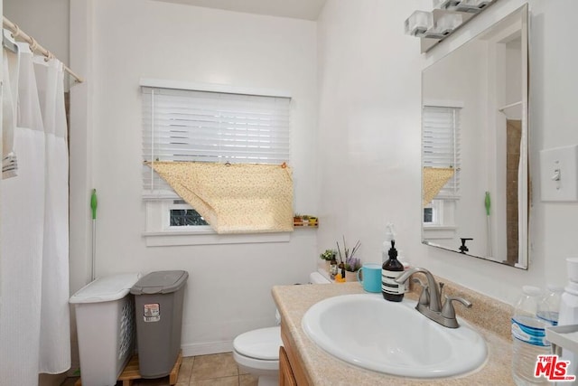 bathroom with oversized vanity, toilet, and tile flooring