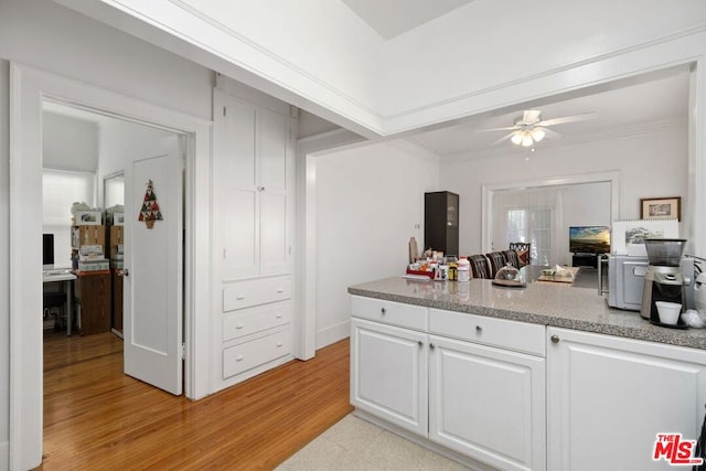 kitchen featuring white cabinets, ceiling fan, and light hardwood / wood-style floors