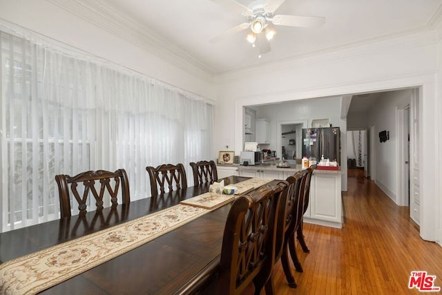 dining space with light hardwood / wood-style floors, ornamental molding, and ceiling fan