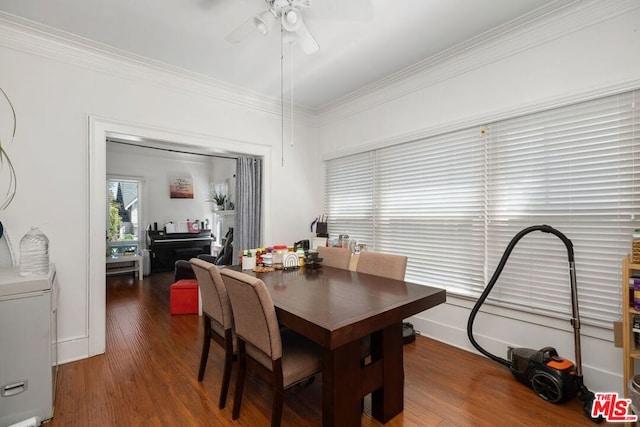 dining room featuring ceiling fan, dark wood-type flooring, and ornamental molding