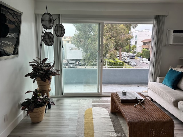 doorway to outside featuring an AC wall unit and hardwood / wood-style floors