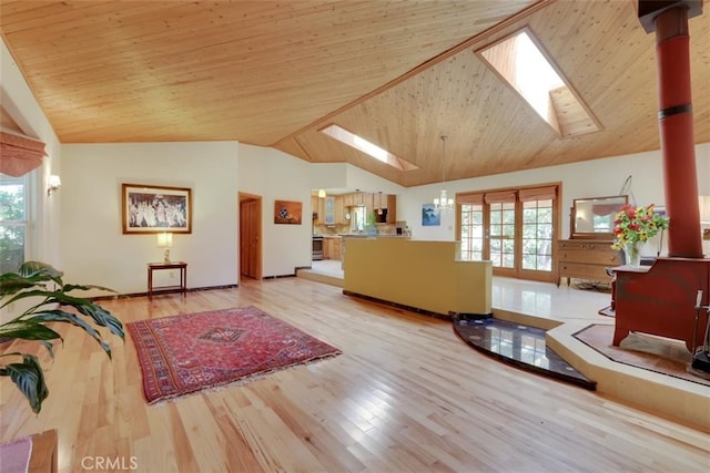 living room with wood ceiling, light hardwood / wood-style floors, and lofted ceiling with skylight