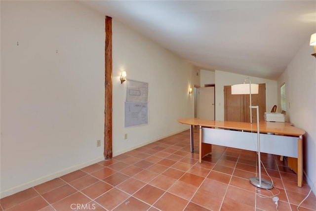 tiled office featuring vaulted ceiling