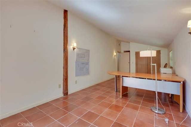 tiled home office featuring vaulted ceiling