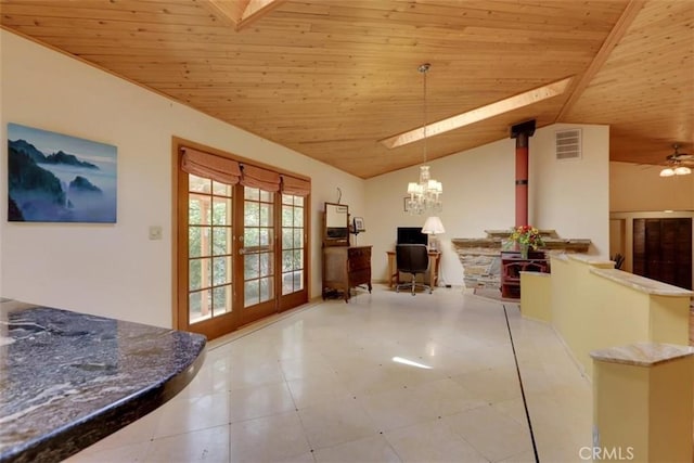 living room featuring a wood stove, visible vents, vaulted ceiling, wood ceiling, and french doors