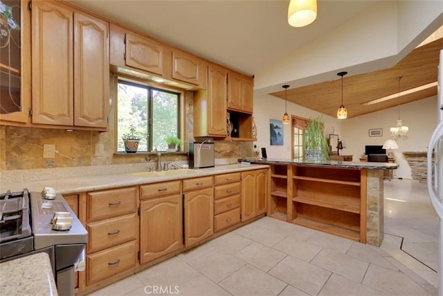 kitchen with a wealth of natural light, tasteful backsplash, stainless steel gas range, and lofted ceiling