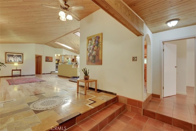 interior space with tile patterned floors, vaulted ceiling, and wooden ceiling