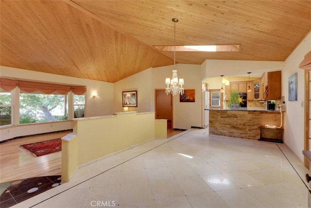 kitchen with a chandelier, a skylight, wooden ceiling, and decorative light fixtures