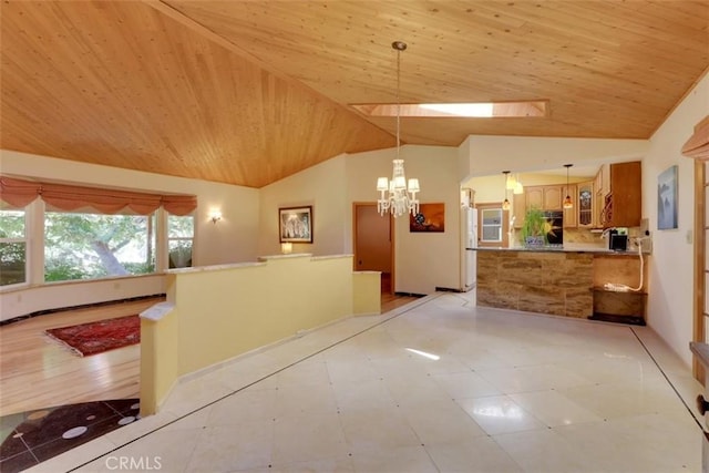 interior space featuring wooden ceiling, an inviting chandelier, and vaulted ceiling
