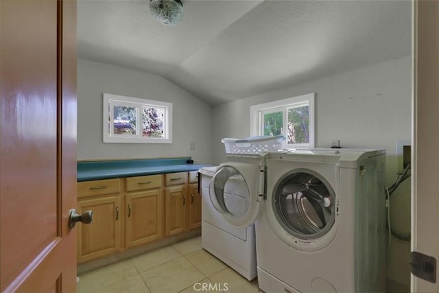 laundry area featuring independent washer and dryer, light tile patterned flooring, and cabinet space