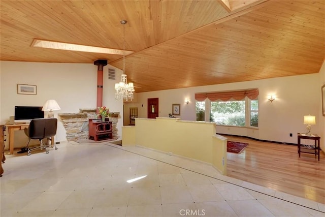 reception area featuring a wood stove and an inviting chandelier