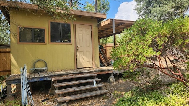 view of outbuilding featuring an outbuilding and fence