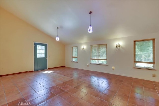 spare room with tile patterned flooring, baseboards, and lofted ceiling
