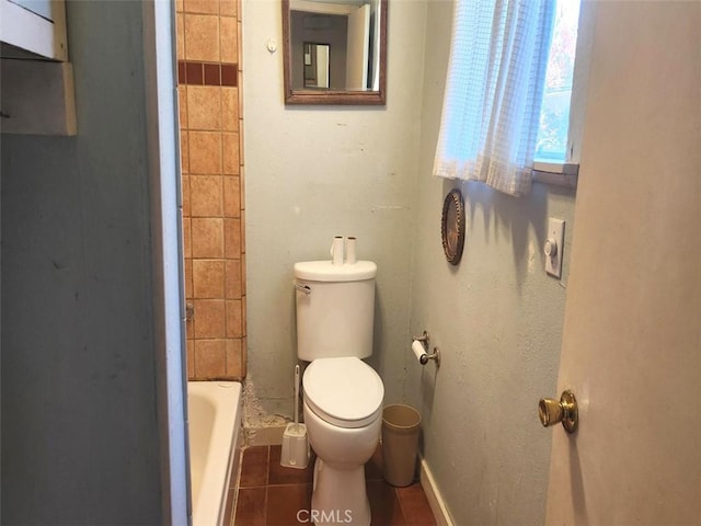 bathroom featuring toilet, tile patterned floors, a bathtub, and a shower